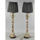 A pair of large ornate table lamps, with shades,