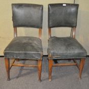 Two early 20th century green leather chairs,