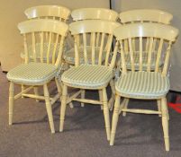 A set of six yellow painted kitchen chairs,