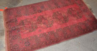 A vintage red ground rug,