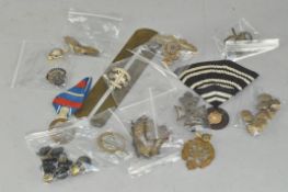A collection of assorted Military cap badges and buttons