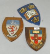 Three wood backed wall shields,