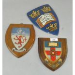 Three wood backed wall shields,