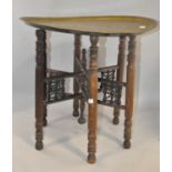 A Middle Eastern brass tray top table, with folding base,