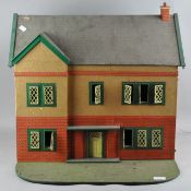 A Victorian two storey dolls house with garden,