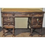 A 19th century oak pedestal desk, with brass handles,