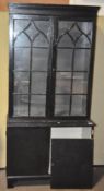A black and white painted bookcase/ display cabinet, in two parts,