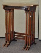 A mahogany nest of three tables, of oval form with inlaid detailing,