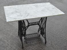 A marble topped iron Singer sewing machine table,