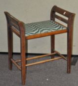 An Edwardian mahogany piano stool, with upholstered seat,