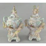 A pair of ornate lidded vases, in the Meissen style, both with twin handles, (one A/F),