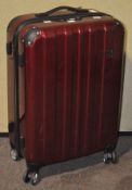 An 'Eminent' lockable suitcase on four wheels