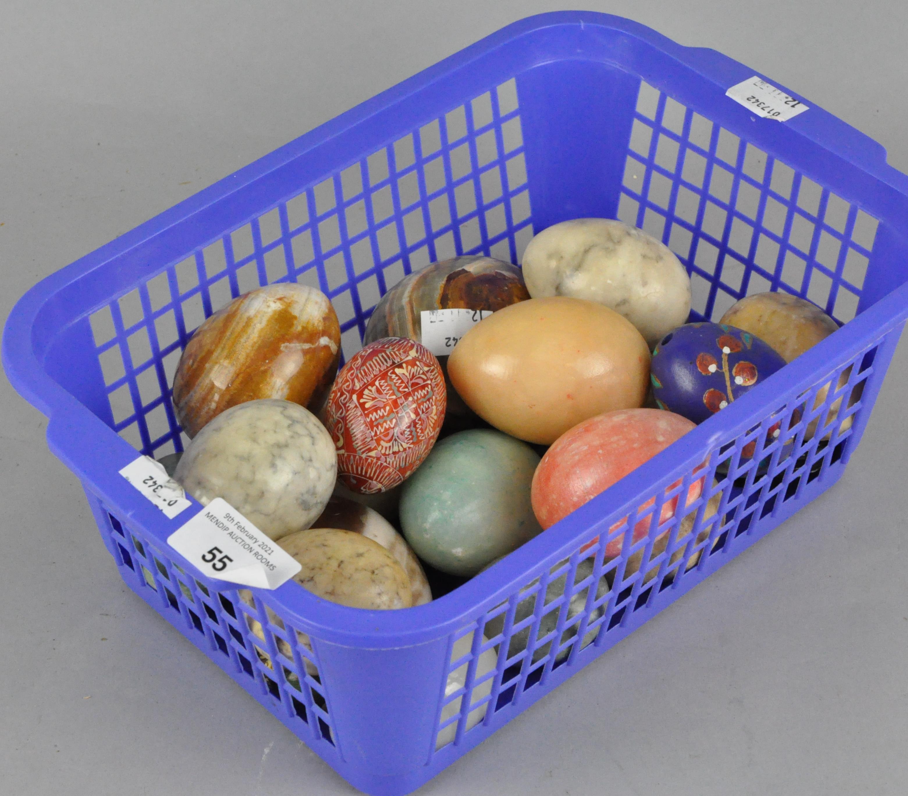 A collection of stone eggs of varying sizes and materials,