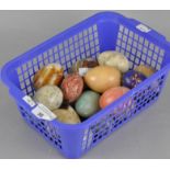 A collection of stone eggs of varying sizes and materials,