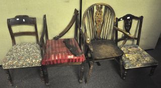 A wheel back armchair, along with three other chairs,
