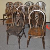 A set of nine oak wheel back dining chairs,