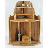 A shelved collectables corner unit with displayed items, including a hip flask,