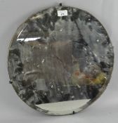 A frameless mirror, of circular form with bevelled edge, 45.