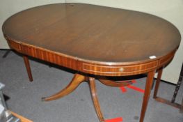 An unusual mahogany pedestal dining table, with folding legs,