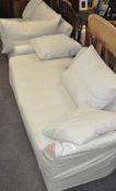 A large two-part corner sofa, with numerous cushions,