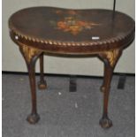 A kidney shaped occasional table, with painted floral scene to top, raised upon claw and ball feet,
