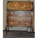 A late 19th/early 20th century walnut bureau, the opening flap with three drawers below,