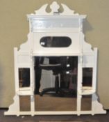 A large white painted over mantel mirror,