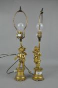 A pair of ornate gilt metal lamps depicting cherubs,