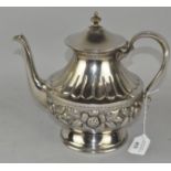 A white metal coffee pot,