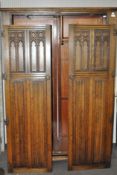 An oak wardrobe with carved decoration to the doors,