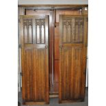 An oak wardrobe with carved decoration to the doors,