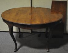A late 19th/early 20th century mahogany extending dining table, with three extra leaves,