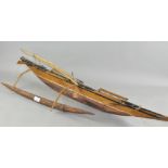 A scratch built wooden model of a boat,
