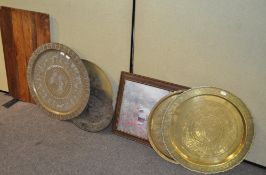 A group of five metal trays, most being Middle Eastern, brass and other metals,