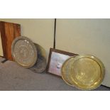 A group of five metal trays, most being Middle Eastern, brass and other metals,