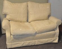 A cream upholstered two seat sofa,