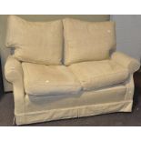 A cream upholstered two seat sofa,