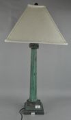 A metal table lamp of Ionic column form, with shade,