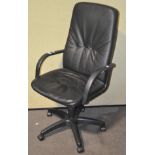 A modern black faux leather office chair,