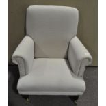A modern grey upholstered armchair,