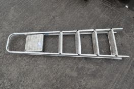 A four tread metal step ladder