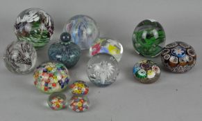 A collection of glass paperweights, including a Kerry glass example,