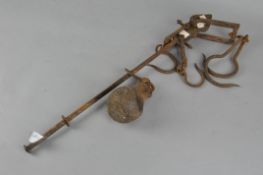 A 19th century cast iron sack weight with two large and two small hooks and a globular weight,