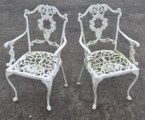 A pair of white painted metal garden chairs,