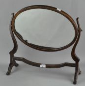 A swing frame mirror, of oval form,