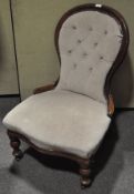 A walnut framed Victorian style balloon back nursing chair, with buttoned upholstery,