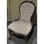 A walnut framed Victorian style balloon back nursing chair, with buttoned upholstery,