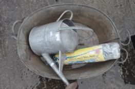 A galvanised metal watering can and two baths