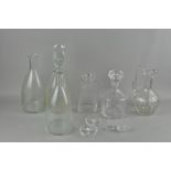 An assortment of glass decanters and other glassware,