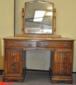 An early 20th century oak dressing table, with mirror, two long drawers over two deep each side,